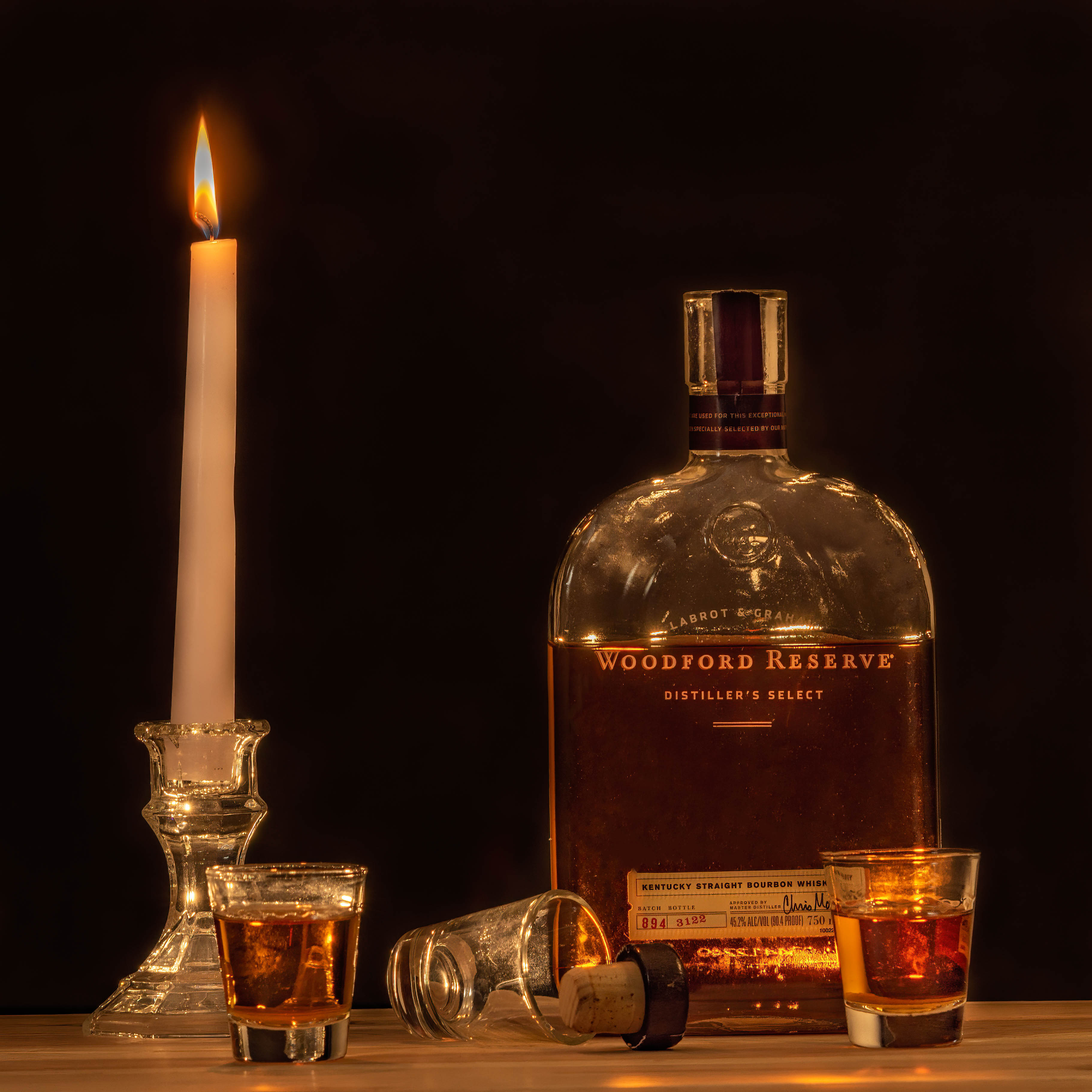 Bourbon composite - shot in studio woodford reserve whiskey shot glasses by candlelight composite shot in studio